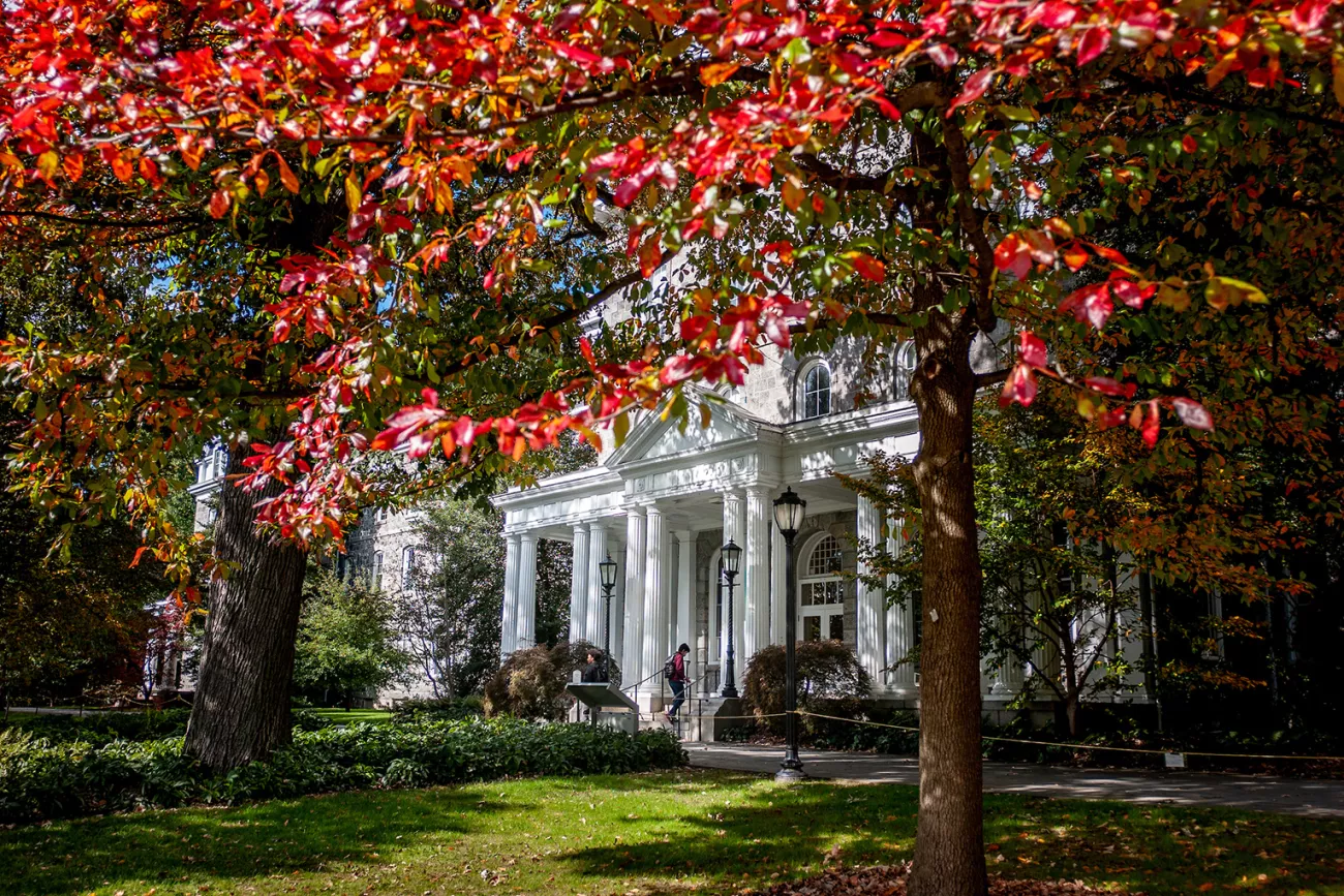 Red leaves in fall season hang over Parrish Hall