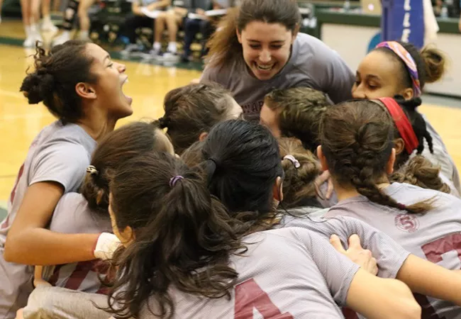 Volleyball team celebrates in dog pile