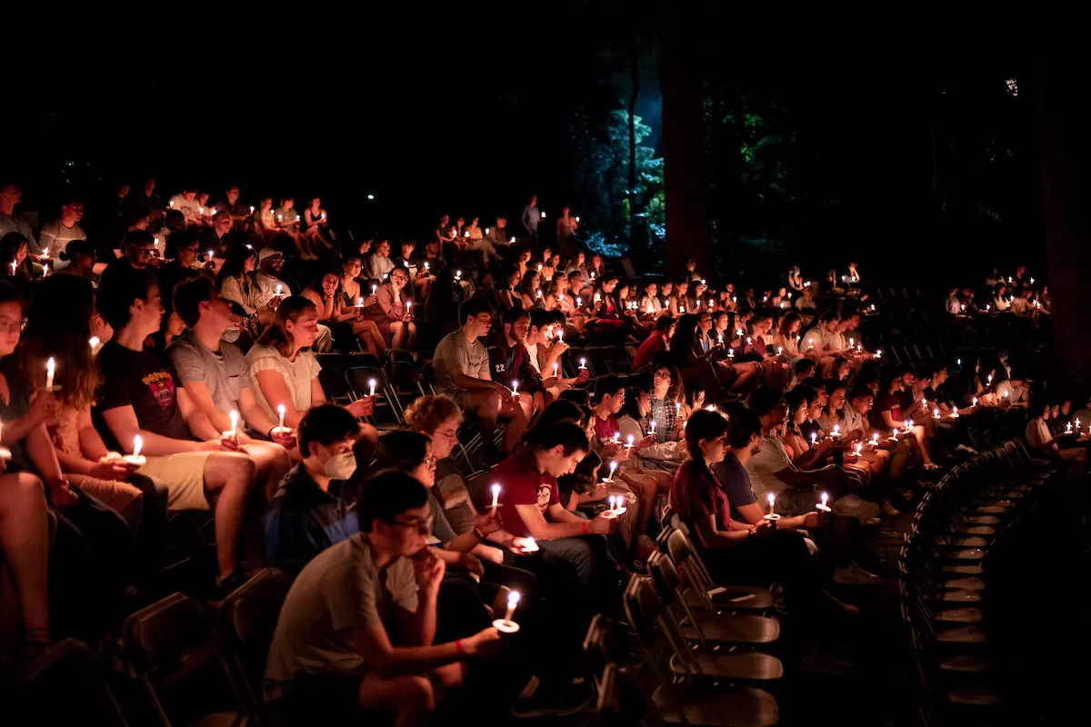 Candlelight illuminates the scene as students gather in the Scott Amphitheater for last collection. 