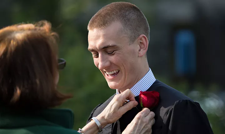 student getting rose pinned