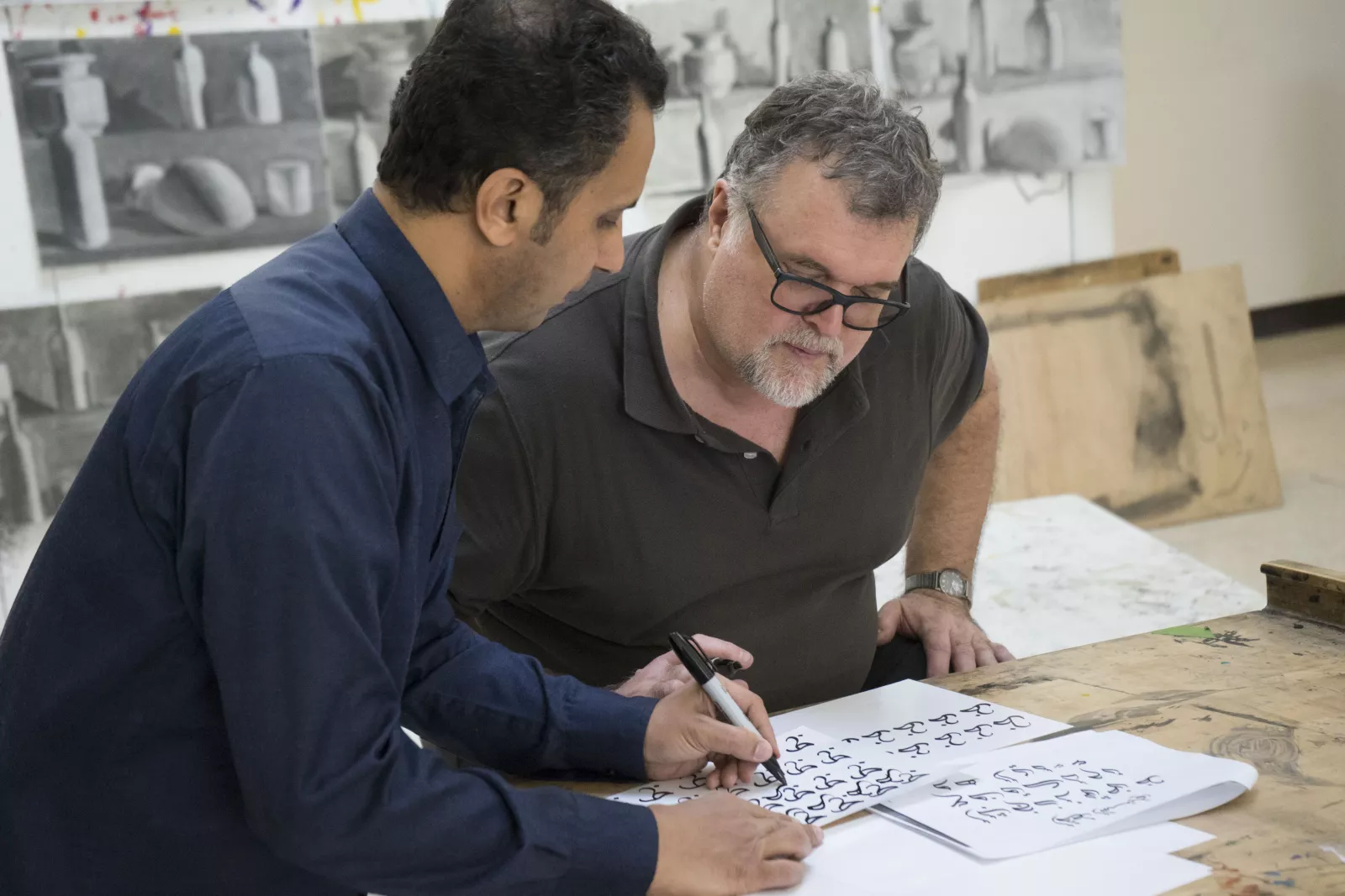 Professor Brian Meunier practices calligraphy