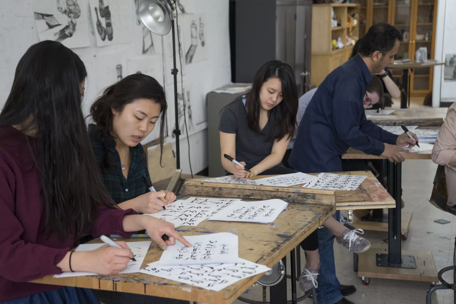 Students practicing calligraphy