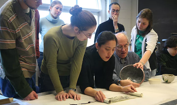 Students examine Japanese scrolls in art history class