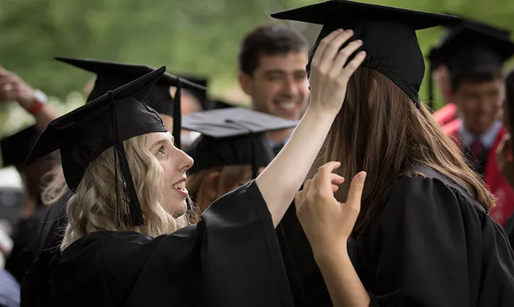 Students help with cap at Baccalaureate 2017.