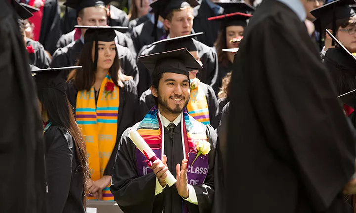 graduates with diplomas