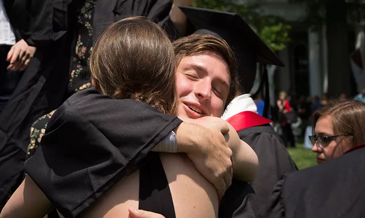 graduates hugging