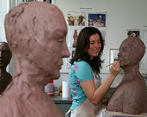 A student works on her sculpture