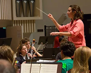 A student composer leads the student orchestra