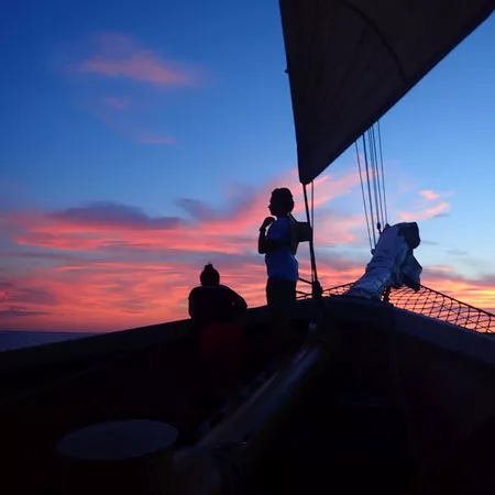 students on a boat by sunset