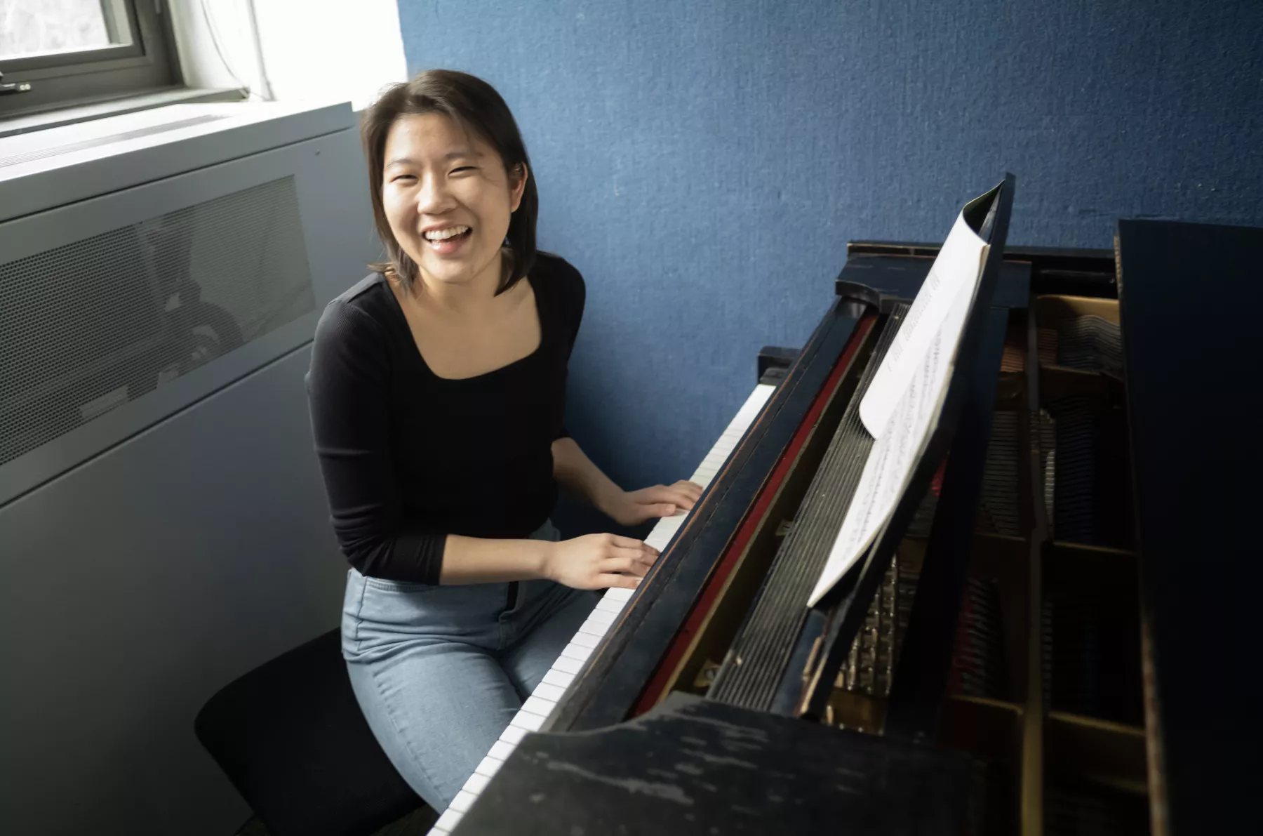 Student sitting at piano keyboard