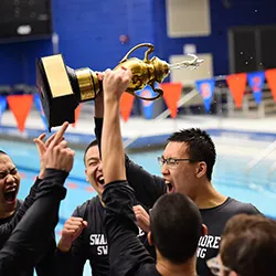 Men's swim team with trophy